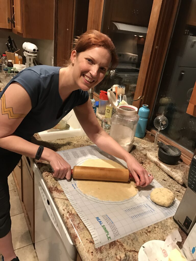 Image of Jen Stafford rolling out a pie crust made from scratch. That rolling pin belonged to my Great Grandma!